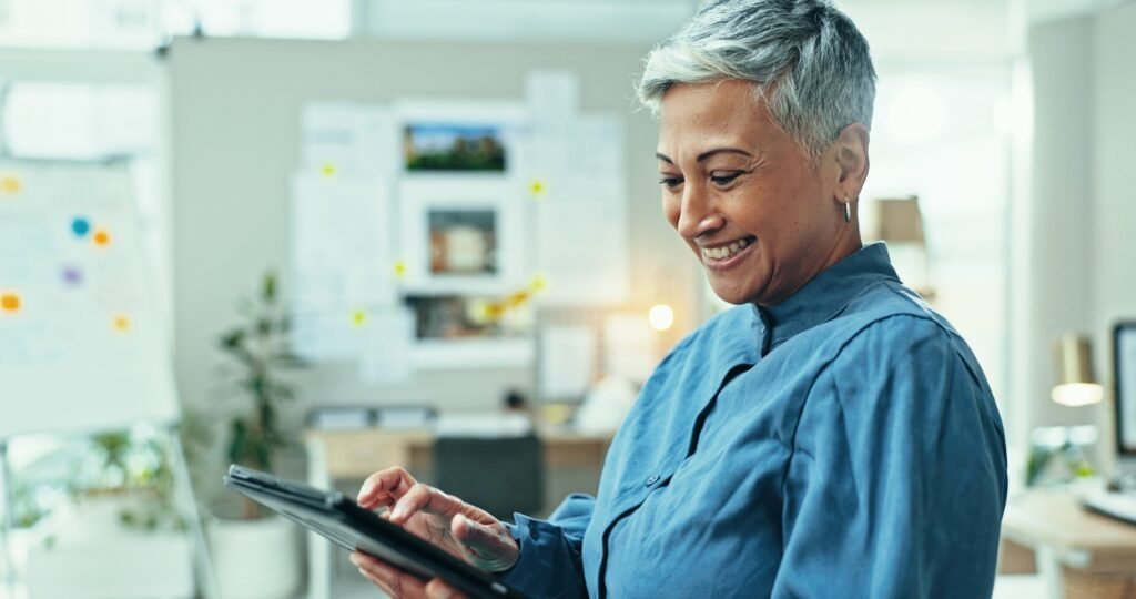 Mature woman, tablet and realtor in office for research online for real estate opportunity or listi