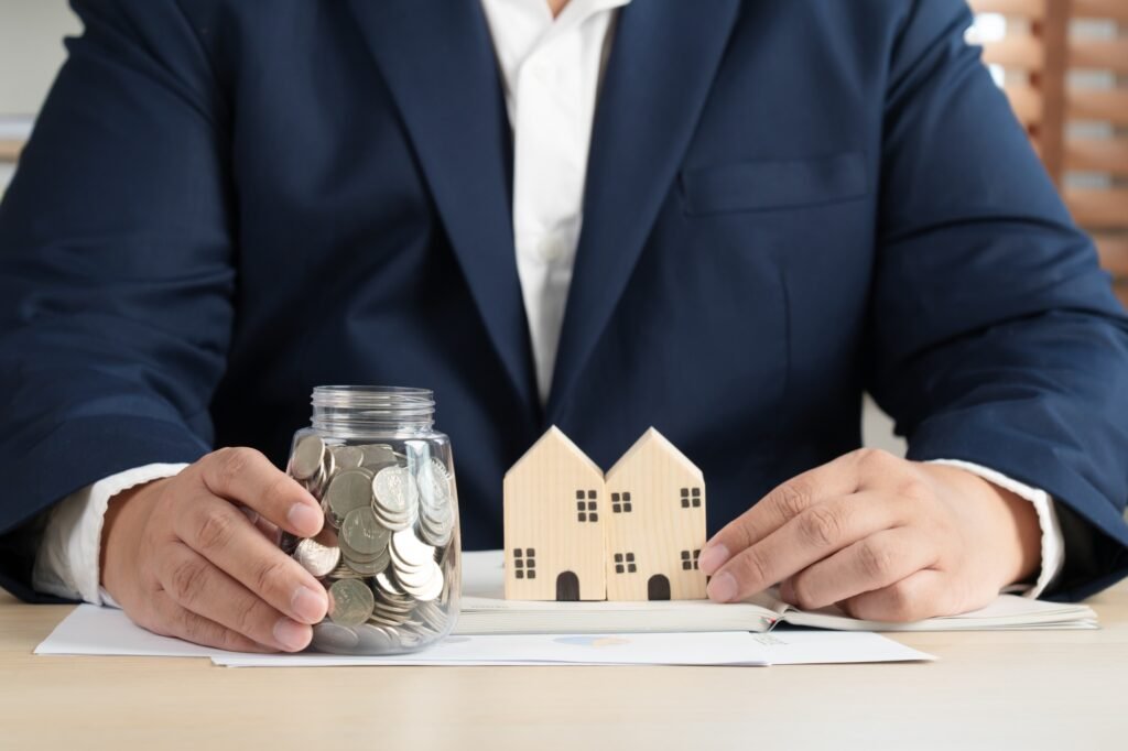 Real estate agent broker or realtor with house and contract plan document paper